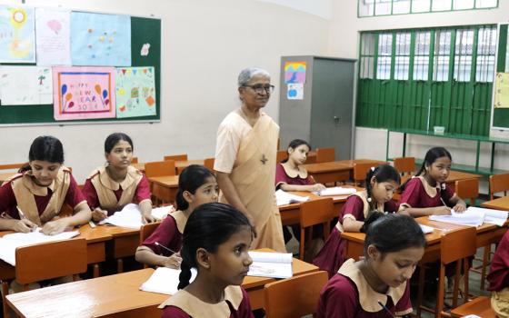 Sr. Lourdes Mary Rozario teaches and supervises a class in the Mohammadpur area of Dhaka, Bangladesh. The Congregation of Our Lady of the Missions Sisters started the Green Herald Evening Charity School program for Bihari children in 1982. (Photo by Stephan Uttom Rozario)