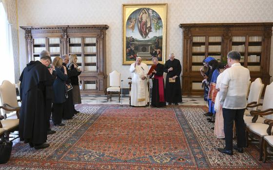 Pope Francis prays with members of the International Network of Societies for Catholic Theology in the library of the Apostolic Palace at the Vatican May 10, 2024. (CNS/Vatican Media)