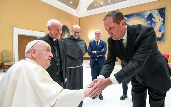 Chuck Robbins bends to shake Pope Francis' hand