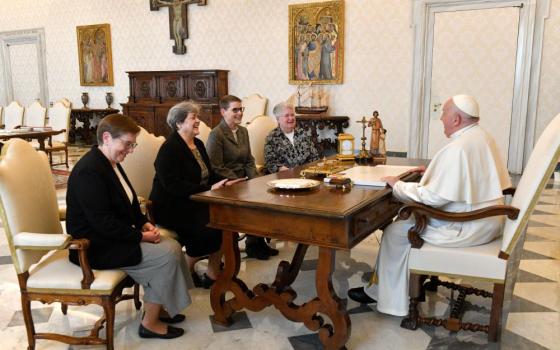 Pope Francis shares a laugh with officers of the U.S. Leadership Conference of Women Religious during a meeting in the library of the Apostolic Palace at the Vatican March 21, 2024. 