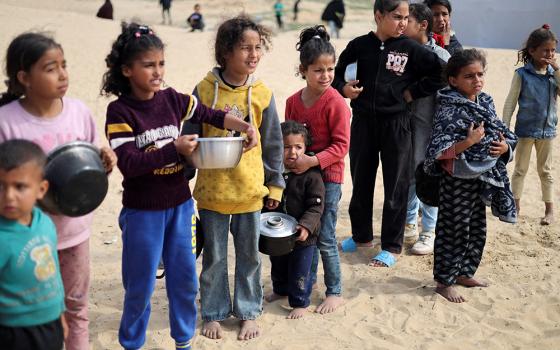 Displaced Palestinian children wait to receive free food at a tent camp, amid food shortages, as the conflict between Israel and Hamas continues, in Rafah in the southern Gaza Strip, Feb. 27, 2024. (OSV News/Reuters/Ibraheem Abu Mustafa)
