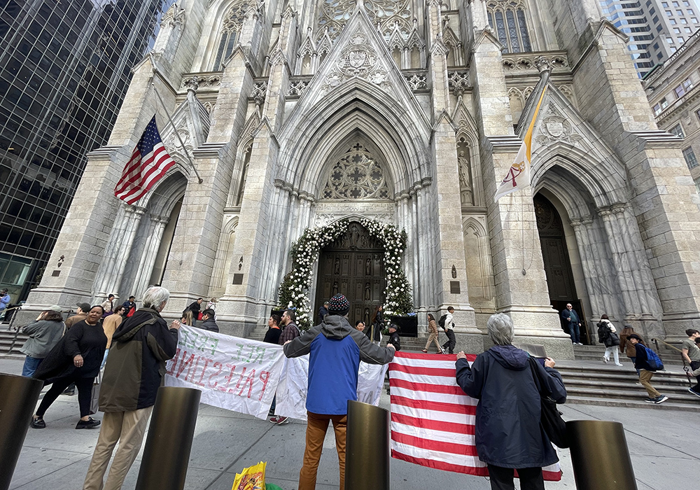 From left: Bernard Connaughton, Carmen Trotta and Cathy Breen of the New York Catholic Worker community are pictured outside St. Patrick's Cathedral during one of their Sunday witness actions. (Courtesy of Liam Myers)