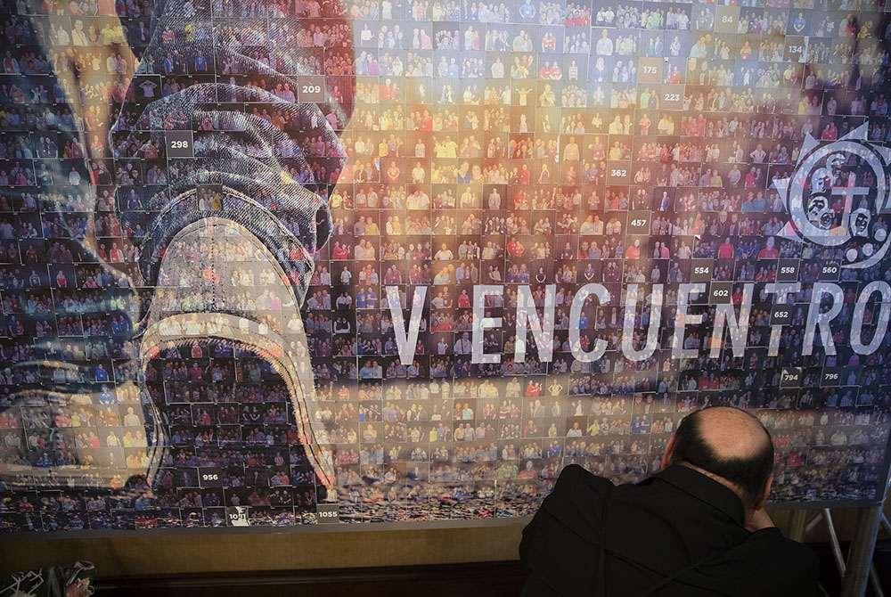 A delegate sticks a picture to a photo booth panel Sept. 22, 2018, during the Fifth National Encuentro in Grapevine, Texas. (CNS/Tyler Orsburn)