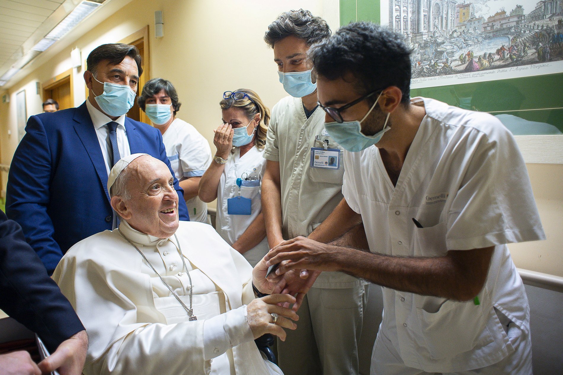 Pope Francis gives a rosary to a member of the medical staff at Gemelli hospital in Rome July 11, 2021, as he recovers following scheduled colon surgery. The pope expressed his gratitude for "making me feel at home" while he recovered from surgery, in a J