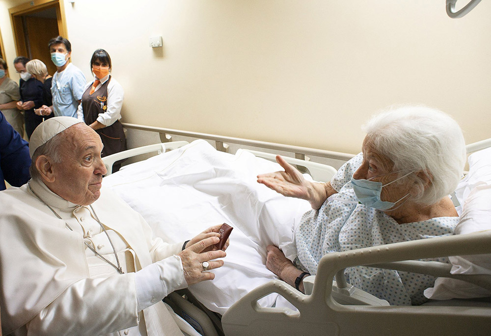 Pope Francis gives a rosary to a patient at Gemelli hospital July 11 in Rome, as he recovers following scheduled colon surgery. The pope was in the hospital for 10 days. (CNS/Vatican Media via Reuters)