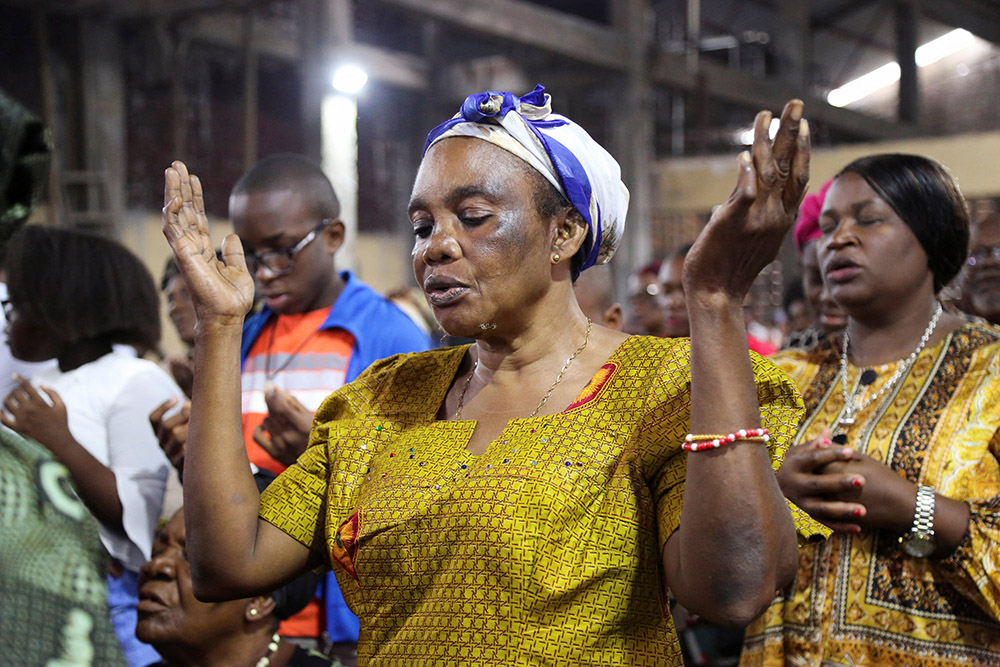 A woman prays during morning Mass at St. Charles Church in Kinshasa, Congo, Jan. 22. (OSV News/Reuters/Justin Makangara)