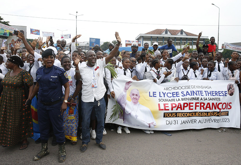 People cheer as they wait for Pope Francis to pass on a road near the international airport Jan. 31 in Kinshasa, Congo. (CNS/Paul Haring)