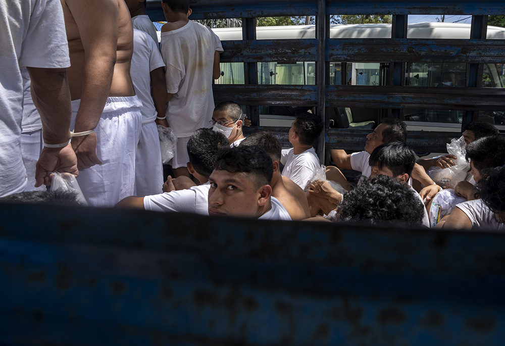 Men detained under the ongoing "state of exception" arrive at a detention center in a cargo truck, Oct. 12, 2022, in Soyapango, El Salvador. The arrests under the "state of exception" have swamped an already overwhelmed criminal justice system, and some defendants arrested on the thinnest of suspicions are dying in prison before any authority looks closely at their cases, according to a network of nongovernmental organizations trying to track them. (AP photo/Moises Castillo)