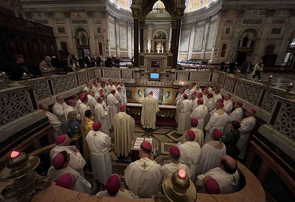 Members of the German bishops' conference pray before the tomb of St. Paul Nov. 17, 2022, during an "ad limina" visit to Rome's Basilica of St. Paul Outside the Walls. (CNS/Deutsche Bischofskonferenz/Daniela Elpers)