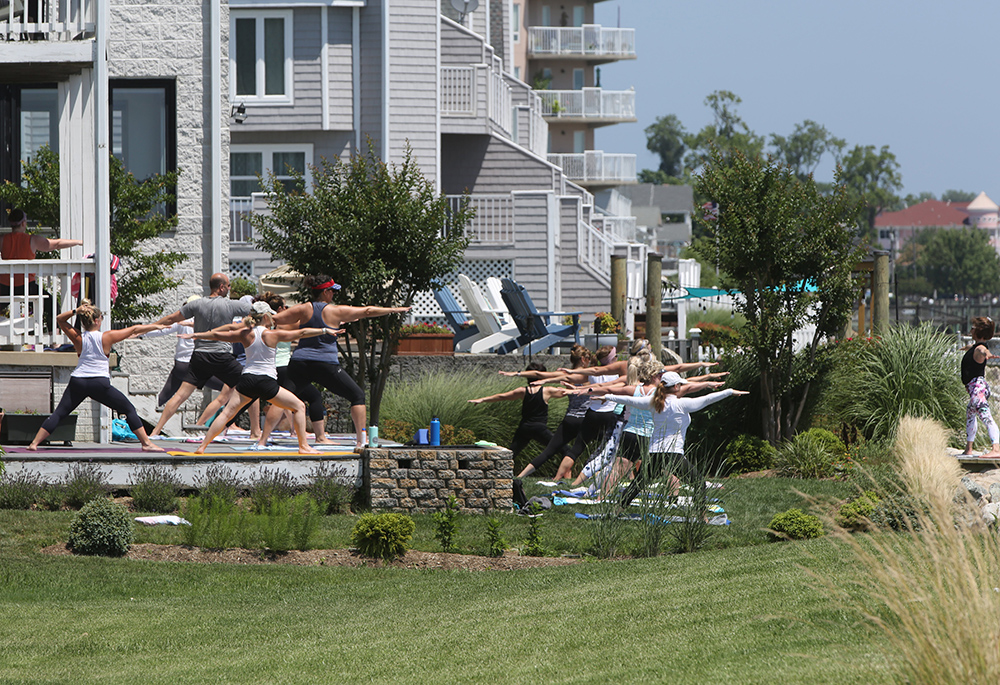 A yoga class is seen outside a home along Maryland's Chesapeake Bay July 1, 2021. (CNS/Bob Roller)