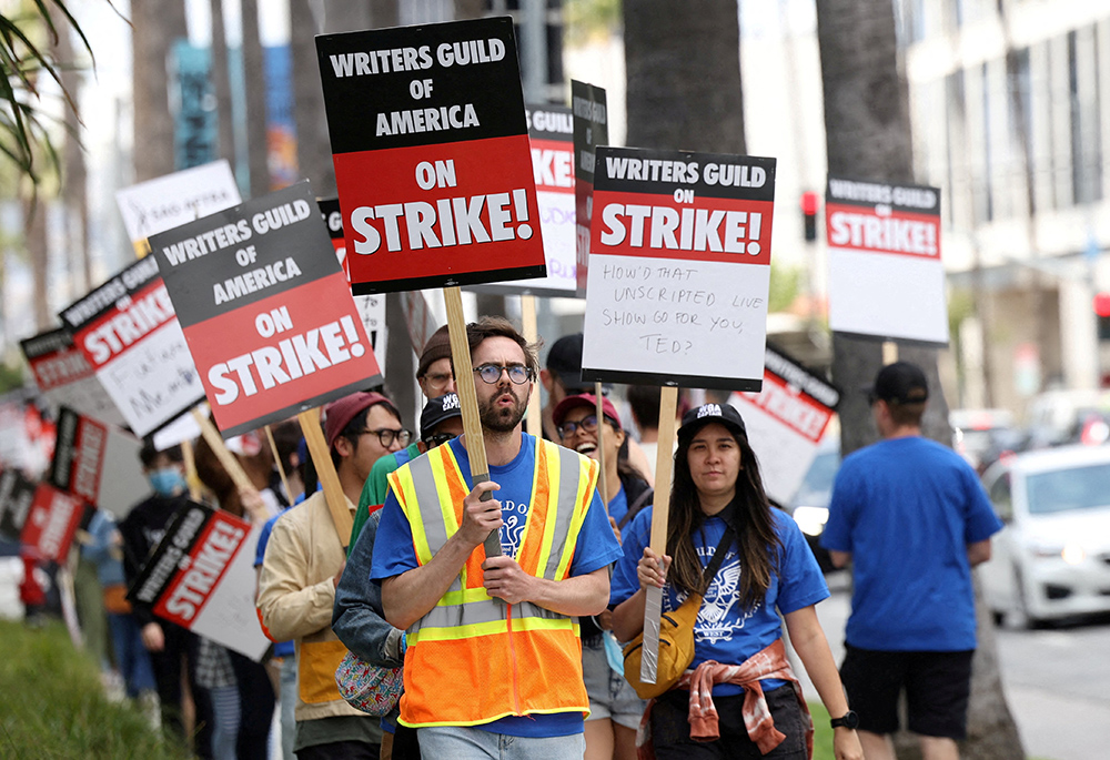 Writers Guild of America members and supporters picket outside Sunset Bronson Studios and Netflix Studios May 3 in Los Angeles, a day after union negotiators called a strike for film and television writers. (OSV News/Reuters/Mario Anzuoni)
