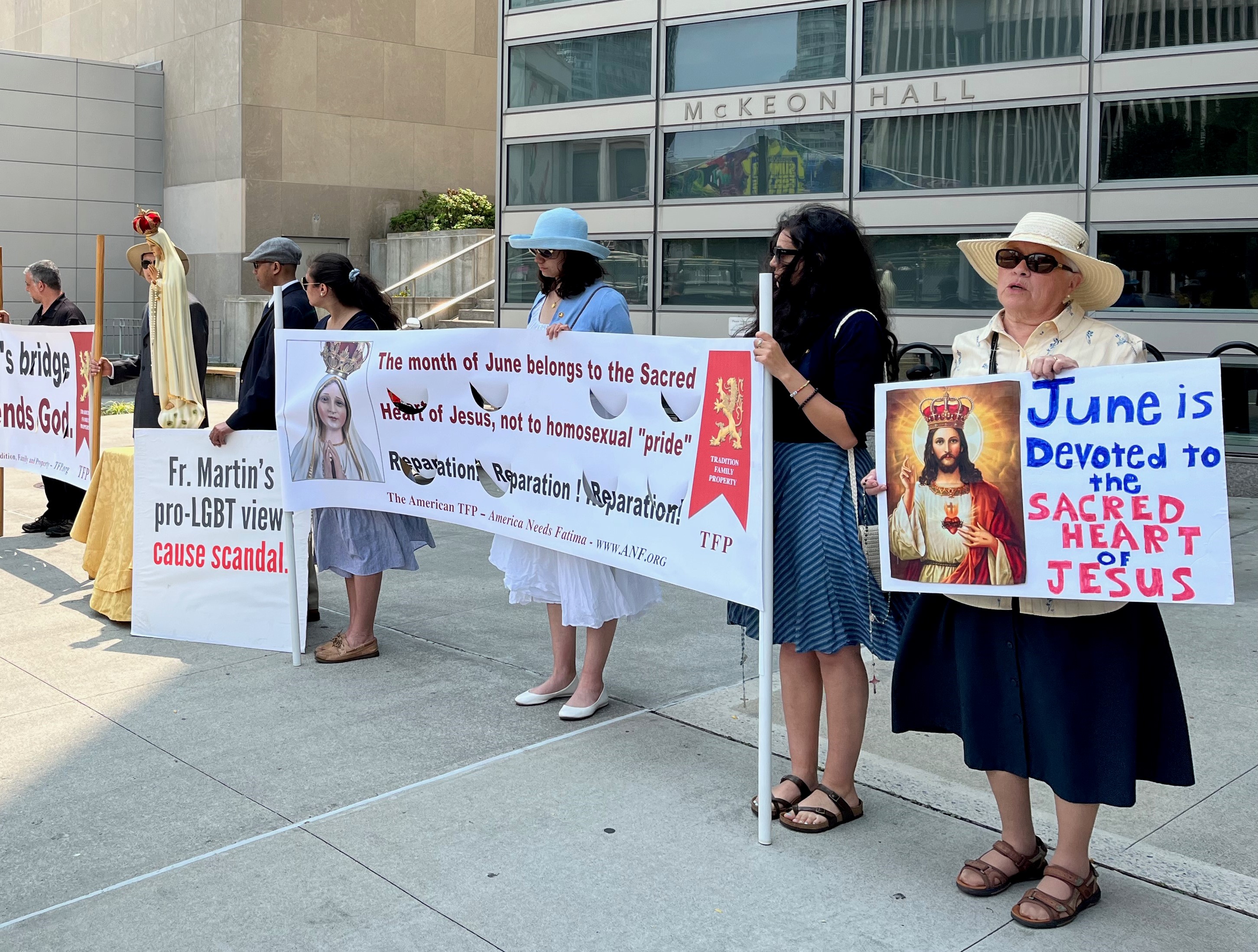 A small group of protesters stood outside Fordham University's Lincoln Center campus on June 17 during the Outreach conference. (NCR photo/Joshua J. McElwee)