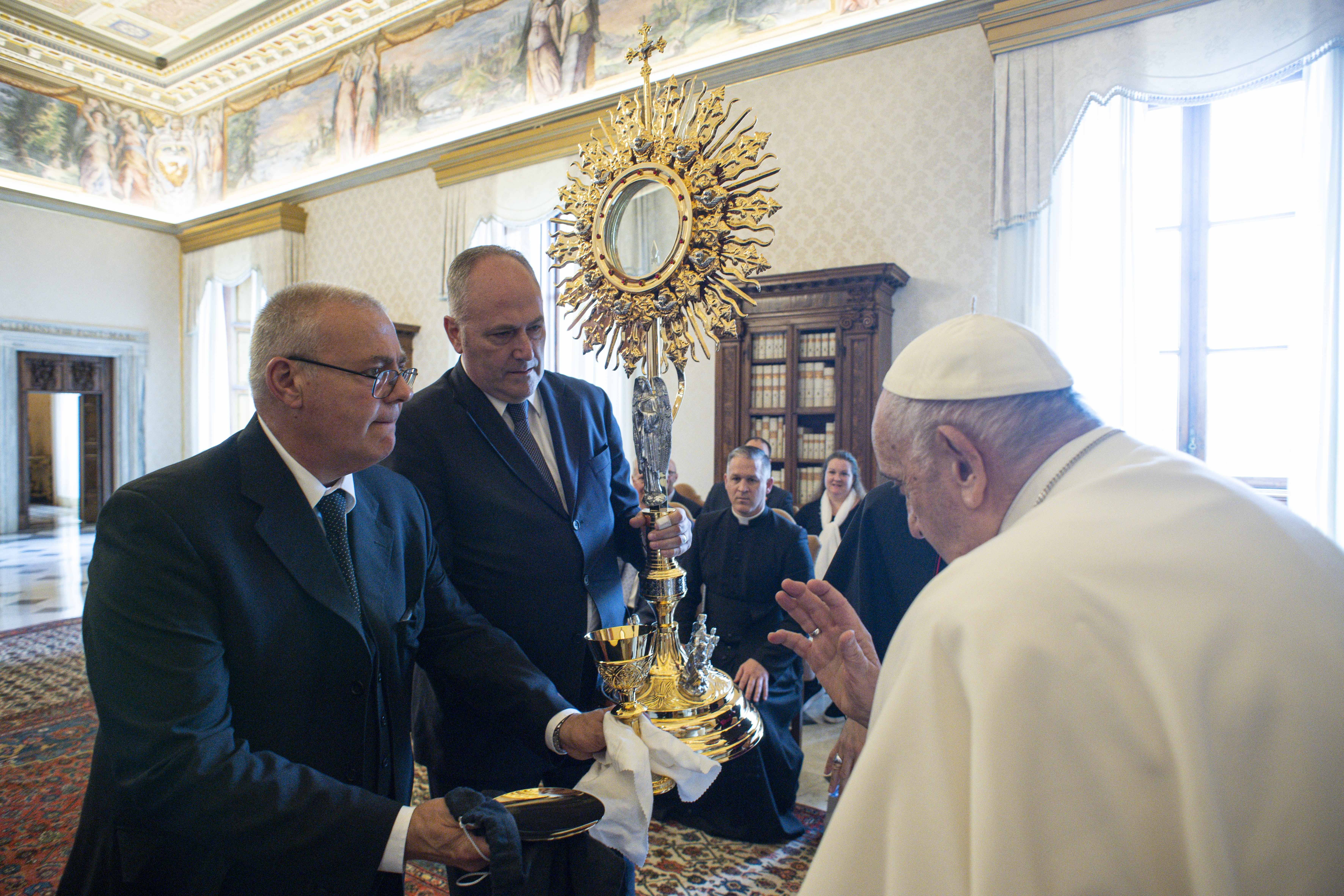 Pope Francis blesses a 4-foot-tall monstrance, a chalice and a paten during an audience with members of the organizing committees of the U.S. National Eucharistic Congress and Eucharistic Revival in the library of the Apostolic Palace at the Vatican June 19. (CNS/Vatican Media)