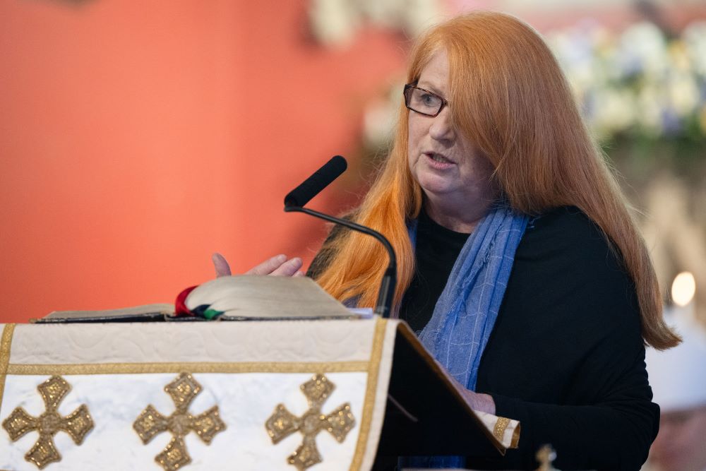Maggie Mathews, a survivor of clergy sex abuse, speaks at the installation of Bishop Stephen Wright July 19. The ribbons represent people "desperately hurt by abuse within the church, many of them abused by priests or religious," she said. (Catholic Church England and Wales/Marcin Mazur)