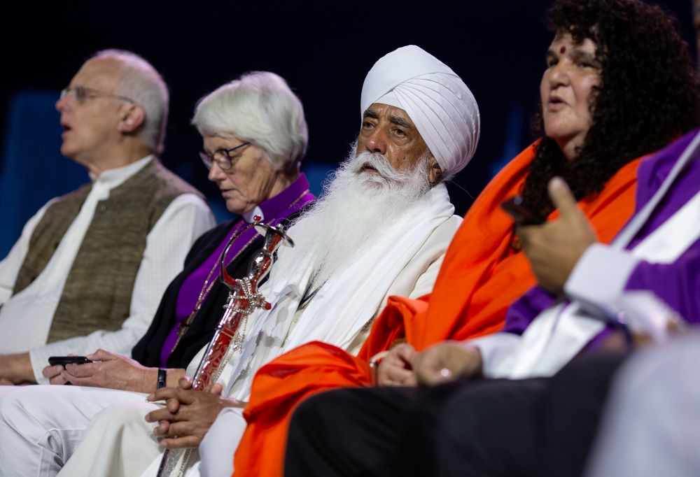 Bhai Mohinder Singh, center, and other religious leaders chant on stage during a climate repentance ceremony at the Parliament of the World’s Religions in Chicago on Aug. 15, 2023. 