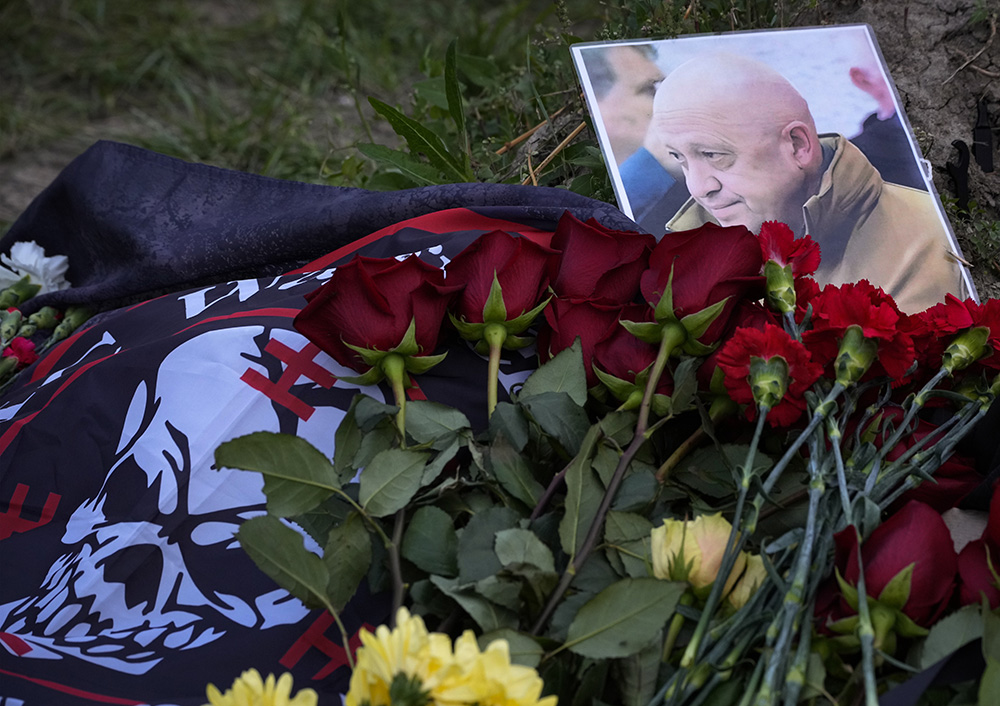 A portrait of the late Yevgeny Prigozhin, head of the Wagner mercenary group, lays at an informal memorial in St. Petersburg, Russia, Aug. 24. (AP Photo/Dmitri Lovetsky)