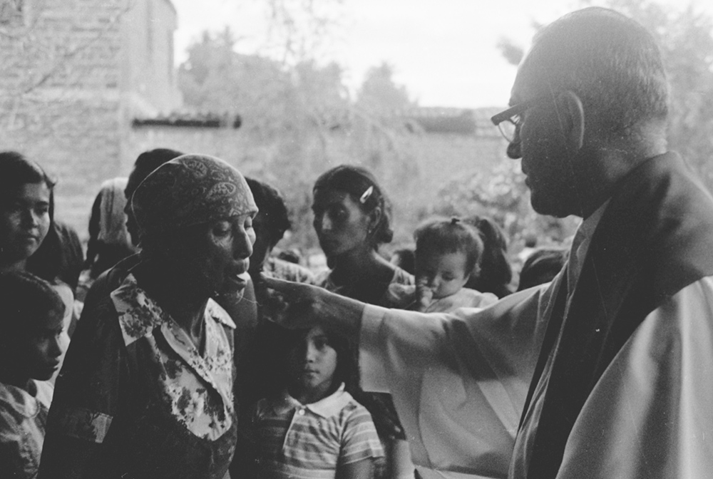 Archbishop Óscar Romero offers Communion to a woman during a confirmation Mass in Ateos, El Salvador, in September 1979. (NCR photo/June Carolyn Erlick)
