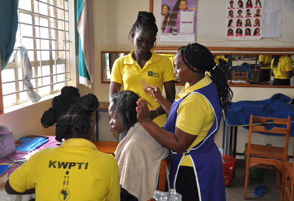 Students of hairdressing plait hair at the institute. The majority of students come from the low-income areas of Kariobangi, Korogocho and Huruma. The institute owes its beginnings to a zealous pro-life movement in the Kariobangi parish that saw the need to support young pregnant women. (​​Lourine Oluoch)