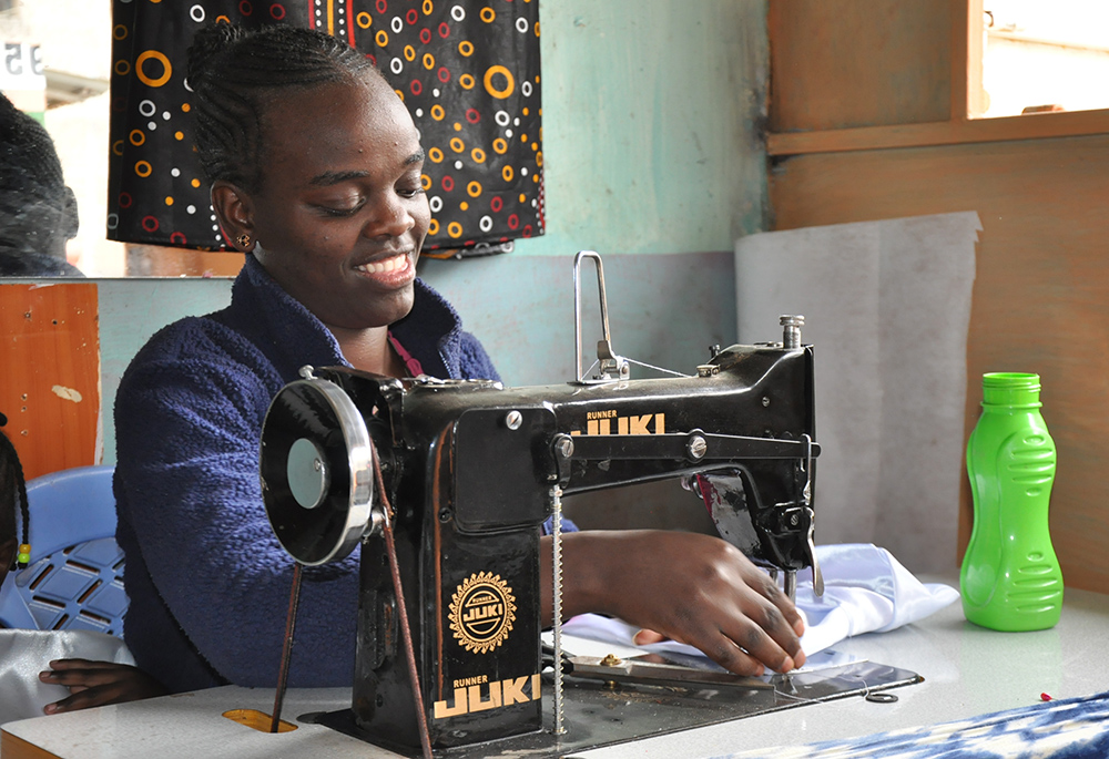 Lynn Chepng'eny is pictured at her dressmaking business in Kariobangi North in Nairobi. Apart from dressmaking and tailoring skills, she says she benefited from counseling and character formation classes at the Kariobangi Women Promotion Training Institute. (​​Lourine Oluoch)