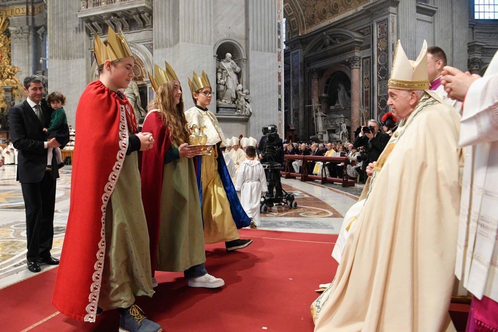 Pope Francis greets children dressed as the Magi as he accepts the offertory gifts during Mass for the feast of Mary, Mother of God, and World Peace Day on New Year's Day in St. Peter’s Basilica at the Vatican Jan. 1. (CNS/Vatican Media)
