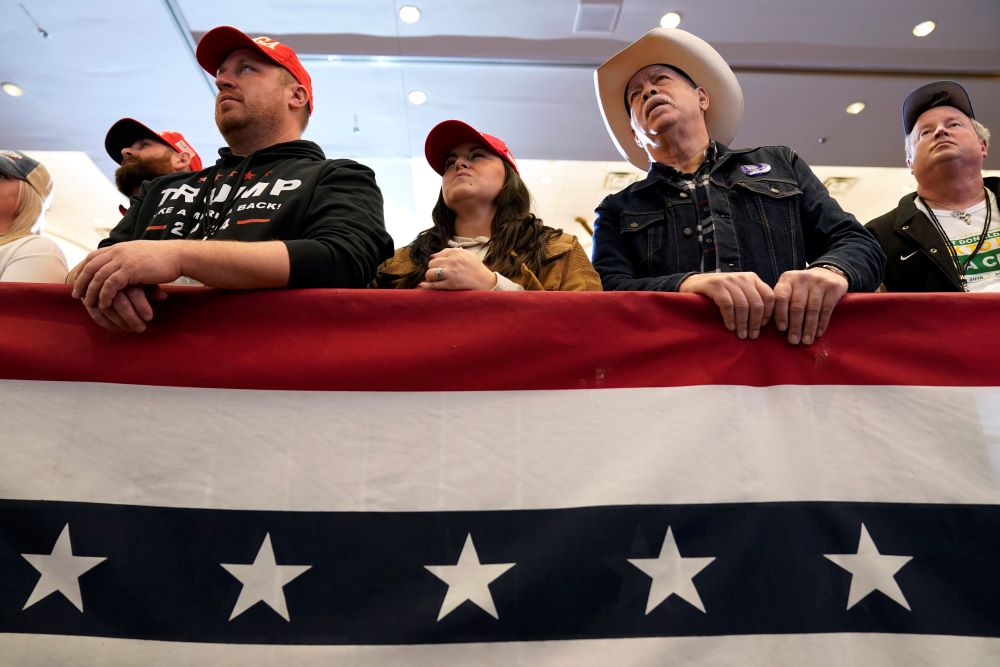 Audience members listen to former President Donald Trump speak during a commit to caucus rally on Dec. 13 in Coralville, Iowa. (AP/Charlie Neibergall, file)