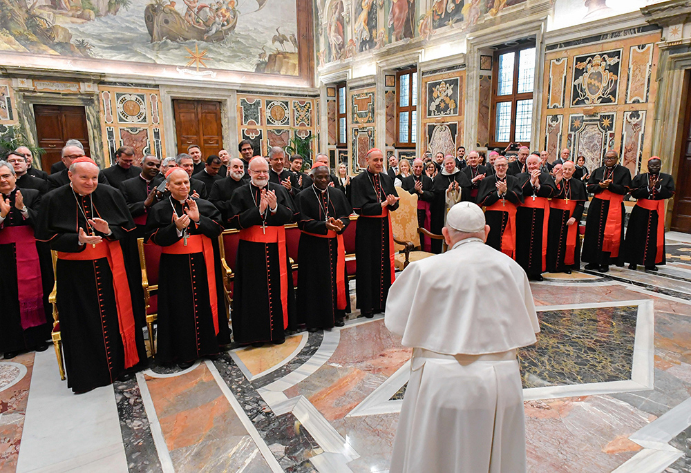 Pope Francis meets members of the Dicastery for the Doctrine of the Faith in the Apostolic Palace Jan. 26 at the Vatican. In the front row from left are: Cardinals Christoph Schönborn, Robert Prevost, Seán O'Malley, Peter Turkson, Victor Manuel Fernández, Claudio Gugerotti, Marc Ouellet, Fernando Filoni, John Onaiyekan and Stephen Mulla. (CNS/Vatican Media)
