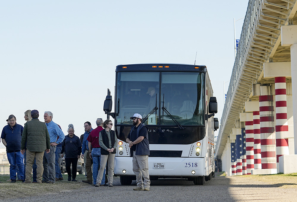 Republican members of Congress arrive via bus at the Texas-Mexico border Jan. 3 in Eagle Pass, Texas. The visit to the border by about 60 congressional Republicans came as they demanded hard-line immigration policies in exchange for backing President Joe Biden's emergency wartime funding request for Ukraine. (AP/Eric Gay)