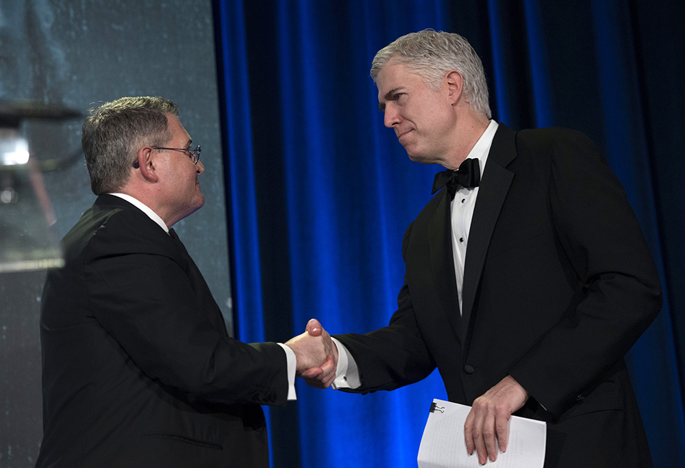 Leonard Leo, left, welcomes Supreme Court Associate Justice Neil Gorsuch for a speech at the Federalist Society's 2017 National Lawyers Convention in Washington, D.C., Nov. 16, 2017. (AP/Sait Serkan Gurbuz)