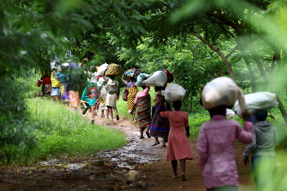 Flood victims from Mtauchira village carry food they received from the Malawi government in Blantyre March 16, 2023, in the aftermath of Cyclone Freddy that destroyed their homes. (OSV News photo/Esa Alexander, Reuters)