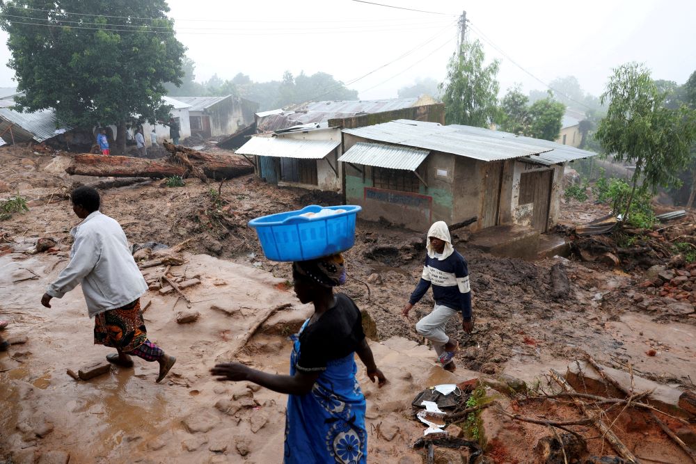 People walk past houses in Blantyre, Malawi, March 17, 2023, which were damaged in the aftermath of Cyclone Freddy. (OSV News photo/Esa Alexander, Reuters)