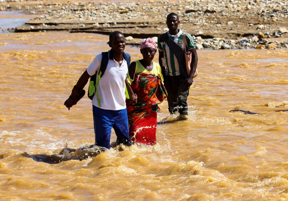 Locals cross a flooded area in Muloza, Malawi, March 17, 2023, in the aftermath of Cyclone Freddy. (OSV News photo/Esa Alexander, Reuters)