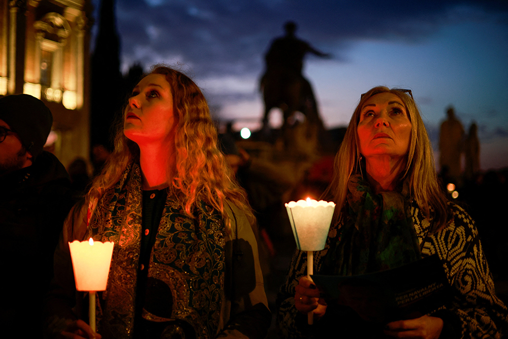 Women hold candles as they attend a vigil in memory of late Russian opposition leader Alexei Navalny at the Campidoglio (Capitoline Hill) in Rome Feb. 19, 2024. (OSV News/Reuters/Yara Nardi)