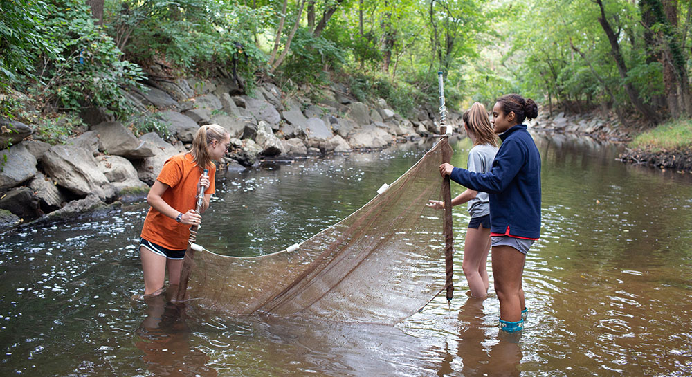 In fall 2019, students in an environmental studies class at Stone Ridge School of the Sacred Heart in Bethesda, Maryland, conduct a stream study in Rock Creek Park in Washington, D.C. (CNS/Courtesy of Catholic Standard/Stone Ridge School of the Sacred Heart)