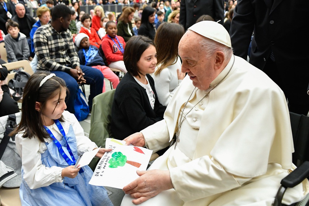 Pope Francis receives a drawing from a child