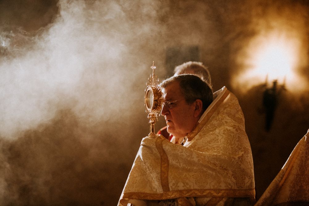 U.S. Cardinal Raymond Burke holds the monstrance during Mass July 25, 2019, at the Napa Institute's annual Summer Conference in California.