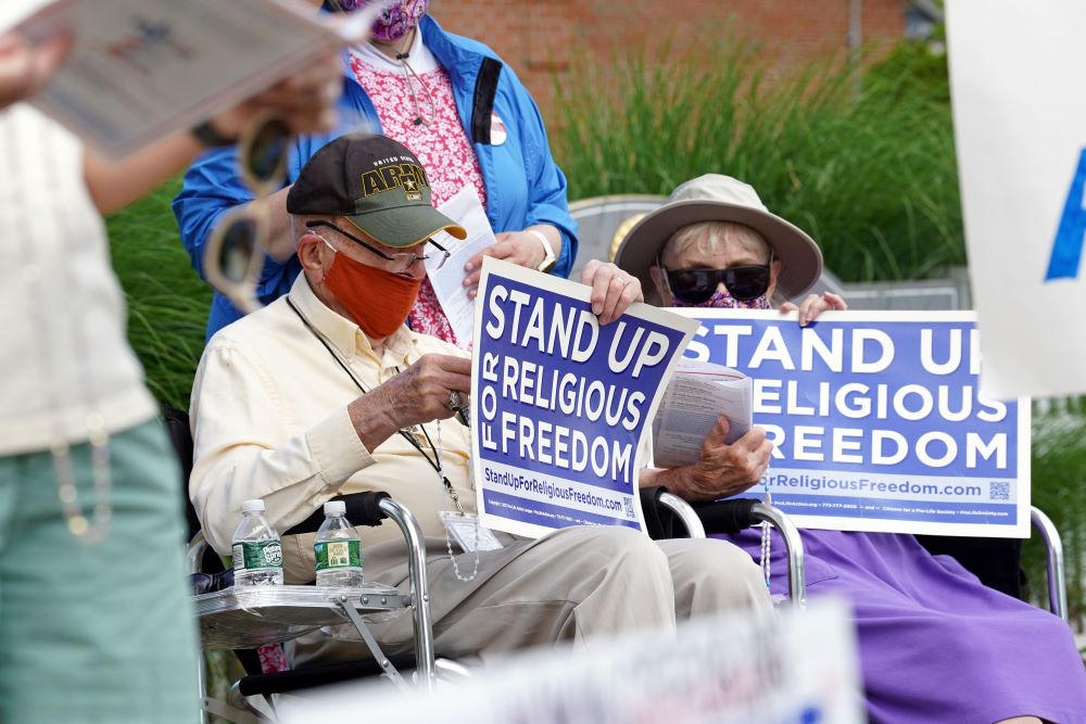 Eric and Anne Waxman recite the rosary while participating in a roadside prayer rally at St. James Church in Setauket, N.Y., June 24, 2020, to mark Religious Freedom Week.