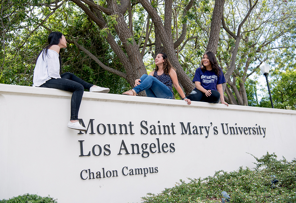 Students at Mount St. Mary's University, Los Angeles seen at the entry sign on campus (Courtesy of Mount St. Mary's University, Los Angeles)