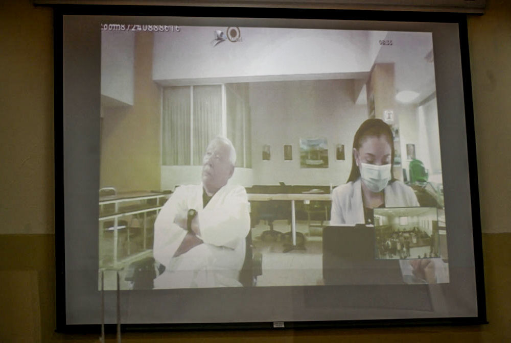Retired Gen. Benedicto Lucas García is seen on a screen during a video call from the ward of a military hospital where he is being held during his trial at a court in Guatemala City on April 5. (AFP via Getty Images/Johan Ordonez)