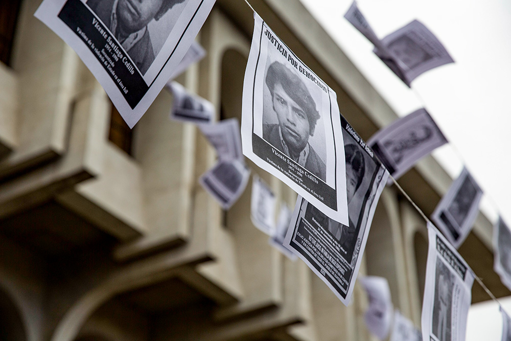Photos of persons who were forcibly disappeared hang in front of the Supreme Court building in Guatemala City Nov. 25, 2019, during a genocide case hearing involving three army commanders, including former Gen. Manuel Benedicto Lucas García, accused of steering the military campaign against the Ixil Maya communities between 1978 and 1982 during the country's civil war. (AP Photo/Moises Castillo)