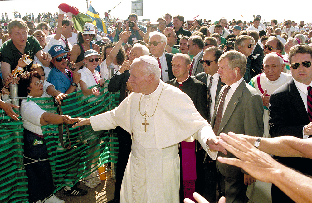 Pope John Paul II greets participants of World Youth Day as he arrives for Mass at Cherry Creek State Park in Aurora, Colorado, Aug. 15, 1993. (AP/Jeff Robbins, File)