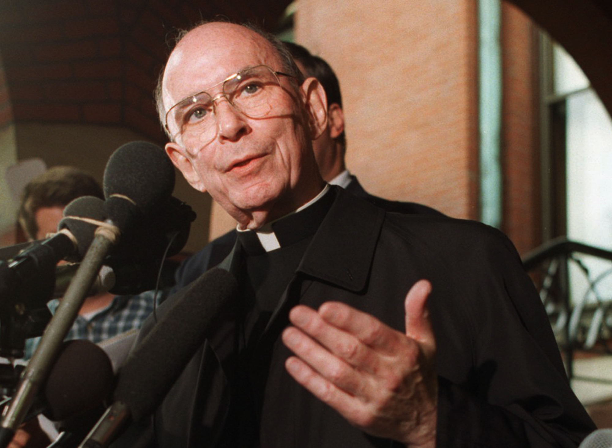 In this Sept. 23, 1996 file photo, Cardinal Joseph Bernardin speaks with reporters on the steps of his Chicago residence just before his departure for Rome to meet with Pope John Paul II. (AP Photo/Peter Barreras, File)