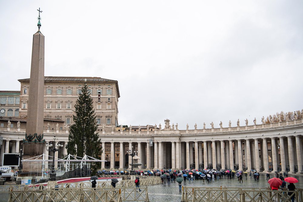 People gather as Pope Francis leads the Angelus from the window of his studio overlooking St. Peter's Square at the Vatican Dec. 6. No pandemic and no kind of crisis can extinguish the light of Christ, the pope said. (CNS/Vatican Media)