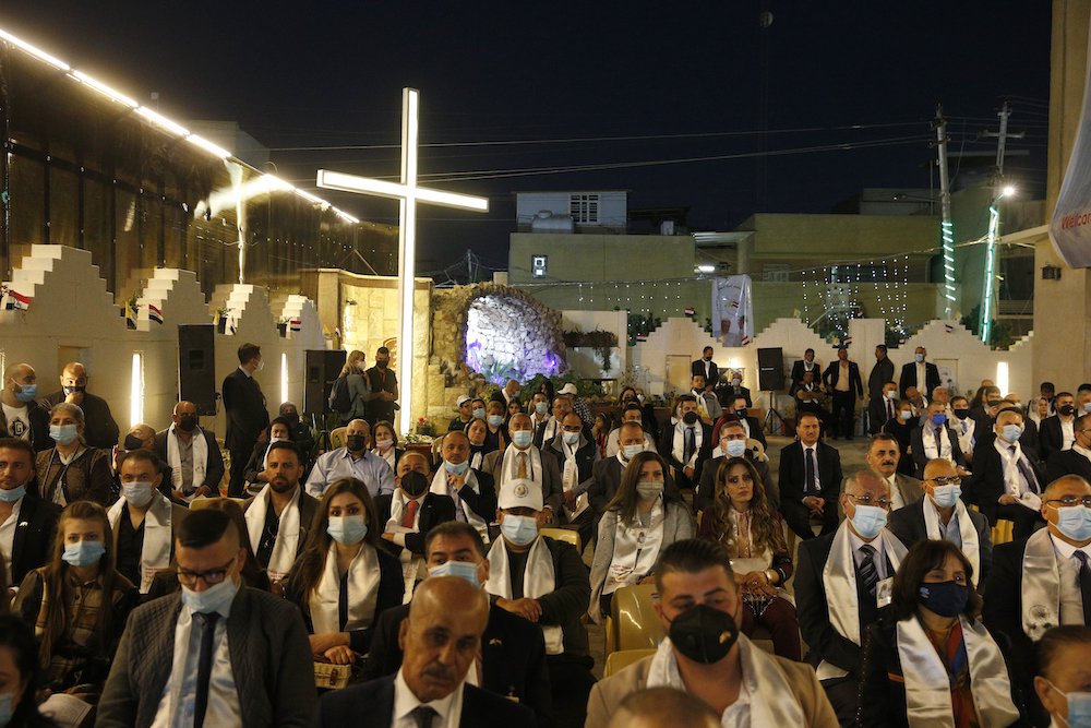 An overflow crowd is seen outside as Pope Francis celebrates Mass at St. Joseph Chaldean Catholic Cathedral in Baghdad March 6, 2021. (CNS/Paul Haring)
