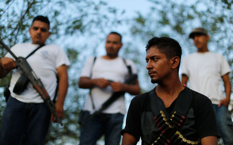 Vigilantes stand guard after hearing rumors of a possible ambush by drug cartels in Michoacán state, Mexico, in January 2013. (Reuters/Alan Ortega)