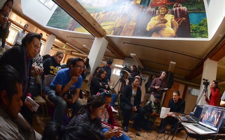 At the Central American Resource Center in Los Angeles, undocumented immigrants, faith- based leaders, labor activists and allies watch President Barack Obama in Las Vegas deliver his plan for immigration reform Jan. 29. (Newscom/Getty Images/AFP/Joe Klamar)