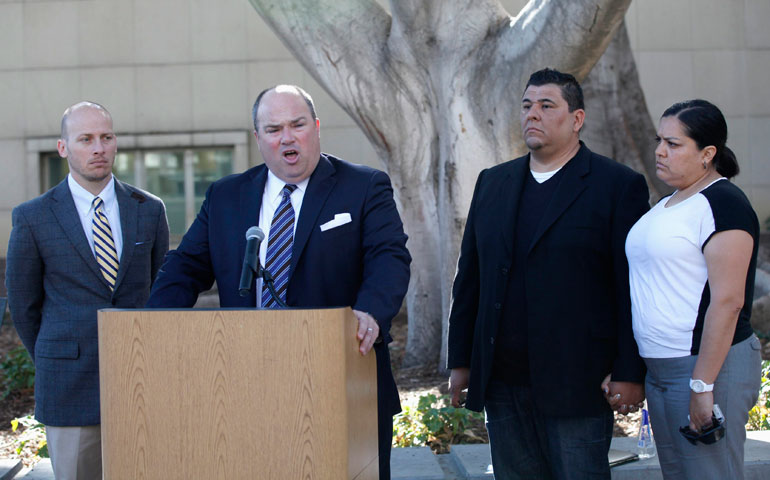 From left, attorneys Vince Finaldi and John Manly, with plaintiff Michael Duran and his wife, Margarita, hold a news conference to announce a settlement of abuse cases against the Los Angeles archdiocese March 14. (Newscom/Reuters/Mario Anzuoni)