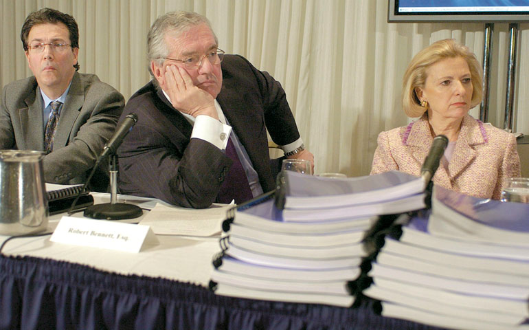 From left, Nicholas Cafardi, lawyer Robert Bennett and Judge Anne Burke listen to remarks at a National Review Board news conference in February 2004 in Washington, D.C. (Newscom/EPA/Mike Theiler)
