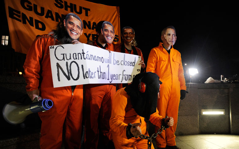 Protesters wearing orange suits and masks of President Barack Obama demonstrate outside the U.S. embassy in London Jan. 11, on the 11th anniversary of the opening of the prison in Guantánamo Bay, Cuba. (Newscom/EPA/Facundo Arrizabalaga)