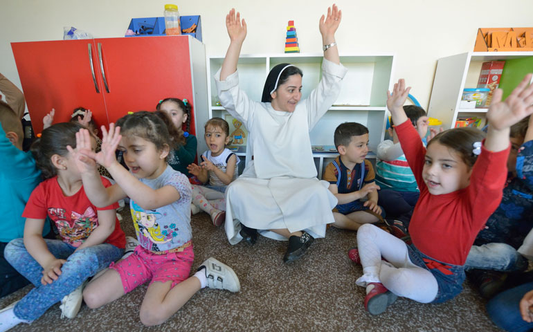 Sr. Ferdos Zora sings along with students April 7 in a preschool for displaced children run by the Dominican Sisters of St. Catherine of Siena in Ankawa, Iraq. (CNS/Paul Jeffrey)