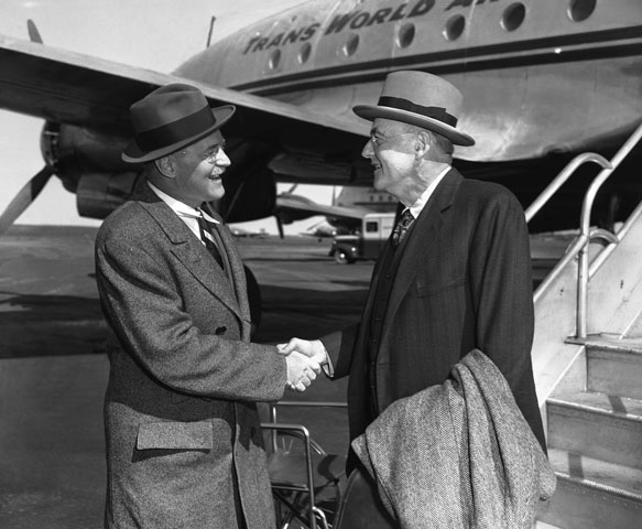 Allen Dulles, left, greets John Foster Dulles at LaGuardia Field in New York in 1948. (AP Photo/Jacob Harris)